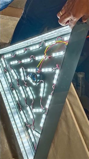 Modern geometric ceiling design with illuminated triangular panels