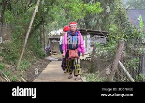 Sapa, Vietnam - march 03, 2020 : Two ethnic hmong women in traditional dress on the street in mountain village in Sapa region, North Vietnam, close up