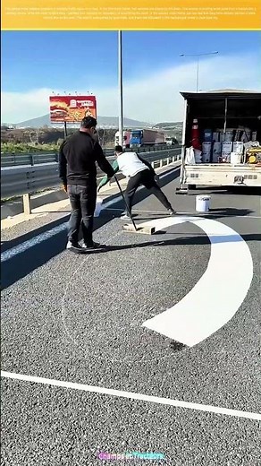 Painting Traffic Signs on the Road: Workers Ensuring Road Safety