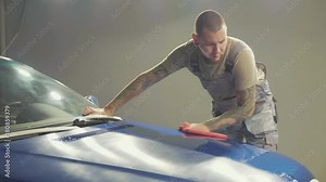 Master finish polish the half hood of deep blue car and wiping the hood Stock Video