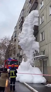 The washing machine malfunctions and suddenly releases an overwhelming wave of foam. It pushes out through every opening, spilling from the balcony and flooding the stairwell inside a multi-story building. The foam spreads rapidly across shared areas, covering everything in sight. Firefighters and police respond to the incident, but the situation remains difficult to control. This text and video are entirely fictional and created using artificial intelligence. | Anatolii Marynyuk