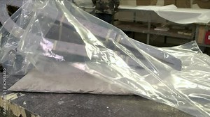Big plastic bag. Worker and polythene. Cellophane as an insulator.