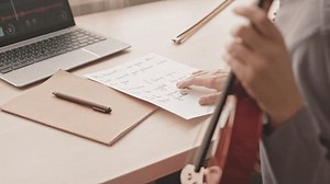 clip-3793118641-cropped-slowmo-unrecognizable-young-woman-reading-song