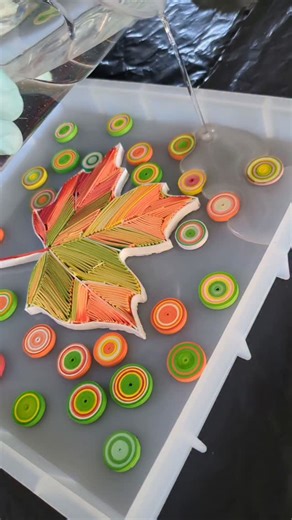 Yulia Brodskaya on Instagram: "I was wondering… 🤔Seeing quite a few comments from people suggesting that I pour resin over my paper artworks, I got curious and decided to give it a try. Luckily, a small leaf from my recent quilling tutorial was lying around collecting dust, so it became the victim of my first resin pour attempt. I’m pretty sure I made every single beginner’s mistake possible (despite watching how-to videos and having my father — who has a degree in chemistry — helping me throug