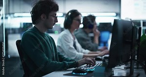 Young Creative Manager Using Computer, Writing a Project Plan for an Innovative Technological Internet Product Launch. Diverse Multicultural Team Working in a Startup Company