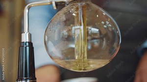Coffee Syphon close up alternative method of making in coffee shop and cafe. Scandinavian coffee brewing method. Brewing process in syphon. Coffee pours down to special glass teapot
