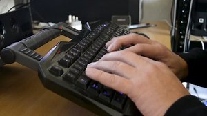 Man using keyboard and printer.