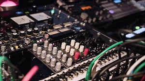 View on knobs, cords, gauges and blinking leds on music switcher board in professional sound production studio