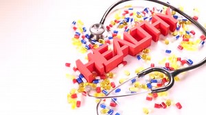 Health sign with stethoscope and pills