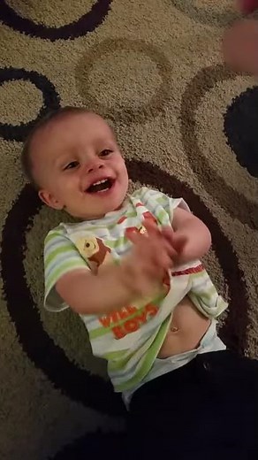 Alex belly laughs while being tickled