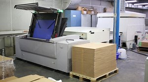 System for loading offset plates into printing machine.