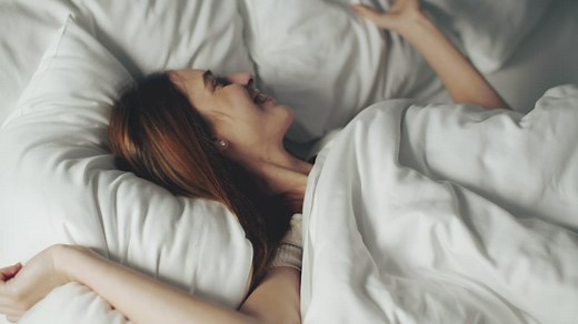 Happy woman waking up in her bed - Free Stock Video