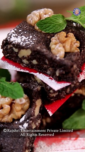 Chocolate Walnut Fudge 💯❤ Ingredients: 400 grams Condensed milk 120 grams Grated Dark chocolate 40 grams salted butter 400 grams toasted walnuts, coarsely crushed 100 grams toasted walnut halves for garnish Garnish Red paper Mint Icing sugar Method: - In a pan, add condensed milk and cook it. - While condensed milk is cooking, add chopped dark chocolate and allow it to melt completely. - While the chocolate is cooking, add salted butter. - On a low flame allow the mixture to boil for 3 to 4 min