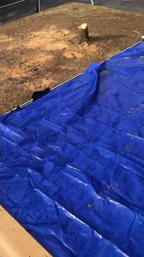 Roofing repair with blue tarp