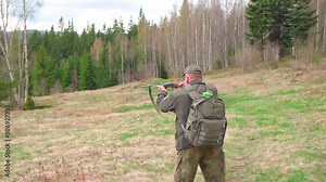 Old Hunter in the woods with his dog. Male hunter hunting with his hunting dog outdoors. German wirehaired pointer. Hunter with his shotgun in middle of nature.