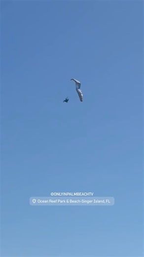 Only In Palm Beach on Instagram: "WOW ‼️🤯 Earlier today, @pbc_oceanrescue Lifeguards from Ocean Reef Park witnessed a powered paraglider hit a major gust of wind in the sky that caused a partial parachute collapse - leading to the paraglider going into a violent spiral just south of #OceanReefPark. This individual went into a major free fall from 500 feet in the air into the ocean in seconds. Lifeguards responded immediately- paddling out to the victim on the #p2prescue board with multiple Resc