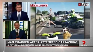 Vision reveals the moment an alleged thief jumps over a roadside barrier in an attempt to flee from police after an alleged carjacking on the Gold Coast. He was forced to jump into the Nerang River, and was arrested a short time later. www.7NEWS.com.au #TheLatest #7NEWS | 7NEWS Australia