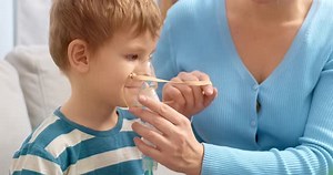 Child Using Nebulizer with Parent's Assistance at Home