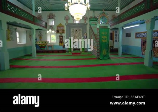 Historic wooden mosque interior with mihrab, carpet, and Islamic prayer hall without people. Sacred architecture shows colorful decoration, religious heritage, Muslim design, spiritual quiet. mosque, wooden, mihrab, islam, interior, prayer Stock Video Footage - Alamy