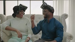 Happy African American family couple Wear virtual reality glasses Play games at home with fun. Use game controller to play Pleasantly. Technology Multimedia and entertainment concept
