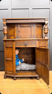 ✨ New Stock Alert! ✨ Check out this beautiful antique oak court cupboard. It’s not only stylish but also super handy! 晴 At the base, there’s a spacious child-sized cupboard—perfect storage during the school holidays!  — As modeled by Albert, aged 7!  #AntiqueFurniture #HomeDecor #VintageFinds #InteriorDesign #KidsStorage #SchoolHolidays #RusticCharm #ShopLocal #DecorInspo | Rustic Warehouse | Facebook