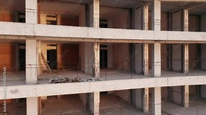 Building under construction - reinforced concrete high-rise multistory tower block renovation. Geometric grid-like pattern of walls and slabs in a housing project. Civil engineering and architecture.