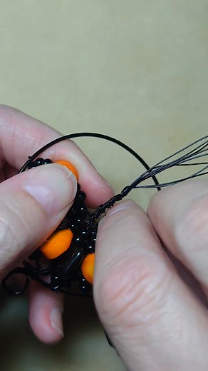 Making a tree-of-life pendant with obsidian and orange bamboo coral beads. So Halloweeny! | Camille Sharon