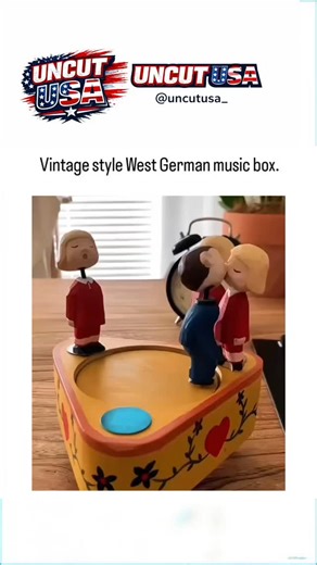 Uncut USA on Instagram: "At first glance this looks like a charming vintage West German music box, gently playing a soft melody while tiny wooden figures move in a loop. But the story behind it is way more modern than the nostalgic label suggests. The piece is a hand-cranked music box featuring animated wooden characters: a man being playfully mobbed by three women as the melody chimes in the background. The exaggerated movements, simple faces, and warm wooden textures give it that classic mid-c
