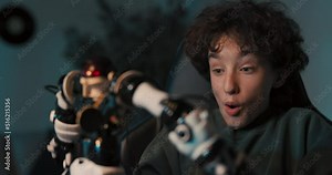 Shocked, the boy programmed the robot using his laptop, the toy came to life began to go crazy. The child was surprised, excited, applauding and happy.