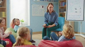 Elementary School Creativity Classroom: Children Sitting on the Bean bags while Teacher Explains Lesson to them and Uses Digital Tablet Computer, They Play by Passing High Five. Slow Motion