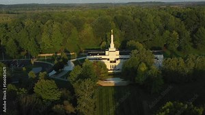 Pull back drone shot of the Palmyra temple near the Joseph Smith family farm, frame house, visitors center, sacred grove in Palmyra New York Origin locations for the Mormons and the book of Mormon.