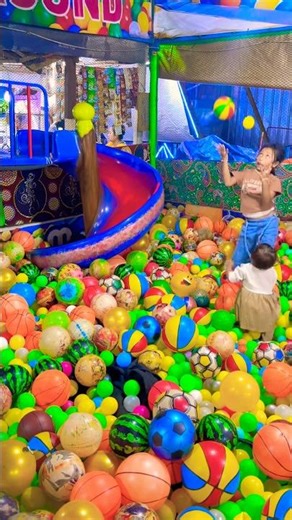 Playing in a rainbow ball pool is fun