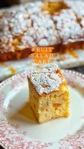 Taghrid Ahmad on Instagram: "Canned Fruit Salad Cake 😋 the perfect light cake alongside a cup of coffee or tea! With pops of fruit with nestled into a vanilla sponge so you get a surprise with every bite! Best of all, it’s one bowl & no mixer needed! Both the fruit + juice are used in this cake, the kids loved snacking on this after school & adding them to their lunch boxes! Note: This batter can be baked in a 20 cm round tin for a taller, higher cake, or in a sheet pan for a shorter, tray-bake