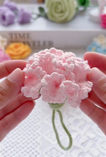 Create a cute crochet carnation charm with this quick and simple tutorial.No sewing needed and perfect for small handmade items to sell or gift.Ideal for Mother’s Day, bouquets, keychains, or decor.A fast project with a beautiful handmade finish. #CrochetForSale #HandmadeGifts #CrochetCharm #CrochetFlowers #SmallCrochetProject | Knot So Hard