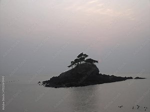 the ebb and flow of the tide to a small island in the sea