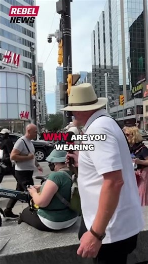 CAUGHT ON CAMERA: Masked trans activist hurls profanity at David Menzies