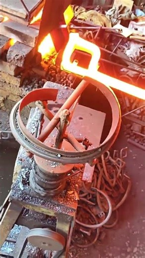 the process of heating iron to make a fire snake shape. #shorts