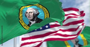 The Washington state flag waving along with the national flag of the United States of America