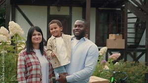 Portrait of a multi-ethnic family with keys who bought a new house. African dad, Caucasian mom, son.Multiracial Family,Mixed Race,Diverse People,Multiethnic Relations