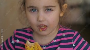 Cute little Caucasian girl eating pizza. Hungry child taking a bite from pizza.