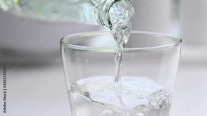 Pouring water from bottle - slow motion