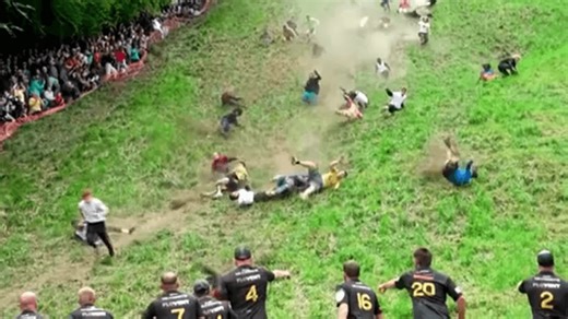 VIDEO: Hundreds chase cheese wheel at annual downhill race