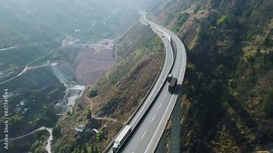 Side View Of Trucks Cars Vehicles Passing Double Lane Highway Bridge In The Mountains Motorway