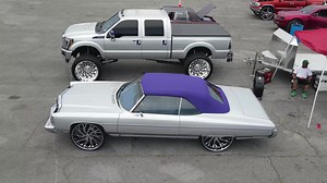 Super Clean Silver 73' Donk Convertible on 28s along with a Silver Ford F250 on 30s | Car Addict