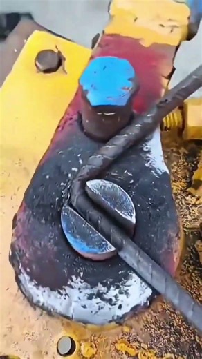 bending a steel rebar using a manual bar bender machine to create a hook for a construction project