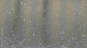 Wet snow (mix of snow and rain) on an autumn day, when the river is not yet frozen, sleet precipitation. Super slow motion 1000 fps