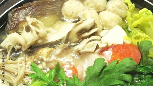 Japanese Hot Pot Cooking in Winter – Steaming Nabemono with Vegetables and Fish Close-Up