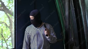 A hooded robber with a gun ambush victims of crime