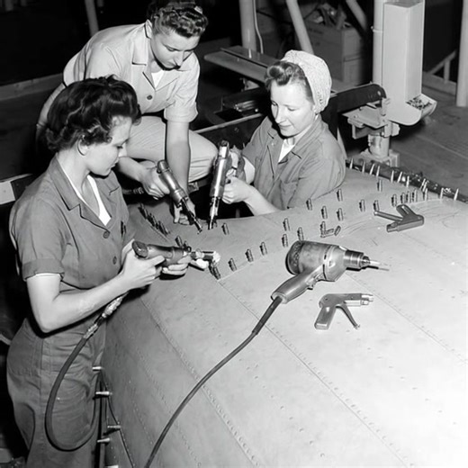 Three “Rosies” install rivets on a B-24 or C-87 fuselage at the Consolidated Aircraft Factory in Fort Worth Texas - 1942 | History of People