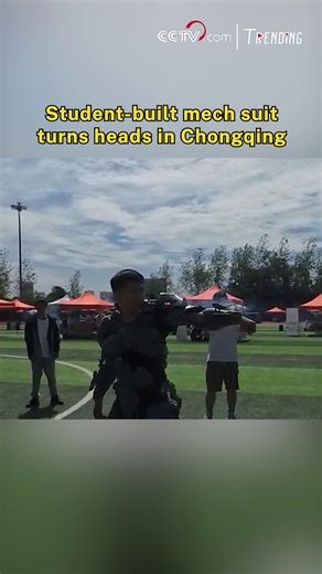 30K views · 270 reactions | In Chongqing, a university senior has crafted a full-scale wearable mech suit entirely by hand over the summer break. The suit can open and close automatically, features smooth mechanical movements, and is even connected to an AI voice system. Inspired by sci-fi films but designed from scratch, the futuristic creation stunned classmates with its sleek look and high-tech feel, earning gasps of amazement across campus. #Trending #ChinaInnovates | CCTV | Facebook